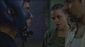 Movie still from “Girlfight” (2000), directed by Karyn Kusama – A woman in a green shirt is looking at a man in a blue boxing glove; Close Up shot, Over the shoulder angle