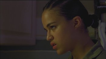 Movie still from “Girlfight” (2000), directed by Karyn Kusama – A young woman looking to her left in a dimly - lit room; Close Up shot, Low angle