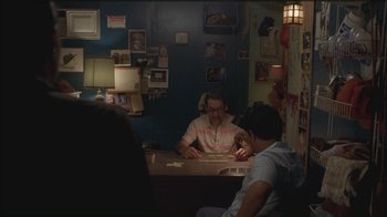 Movie still from “Girlfight” (2000), directed by Karyn Kusama – Two people sitting at a table in a room; Medium shot, Over the shoulder angle