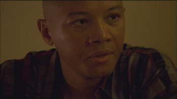 Movie still from “Girlfight” (2000), directed by Karyn Kusama – A man with a bald head is looking at the camera; Close Up shot, Low angle