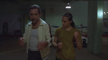 Movie still from “Girlfight” (2000), directed by Karyn Kusama – A man and a woman are standing in a gym; Medium shot, Low angle