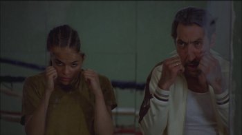 Movie still from “Girlfight” (2000), directed by Karyn Kusama – A man and a woman standing next to each other in a boxing ring; Medium shot, Low angle