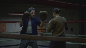 Movie still from “Girlfight” (2000), directed by Karyn Kusama – A man and a woman are boxing in a boxing ring; Medium shot, Low angle