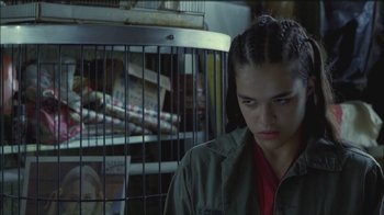 Movie still from “Girlfight” (2000), directed by Karyn Kusama – A woman in a green jacket standing in front of a cage; Close Up shot, Low angle