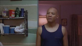 Movie still from “Girlfight” (2000), directed by Karyn Kusama – A man standing in front of a mirror in a room; Medium shot, Over the shoulder angle