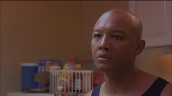 Movie still from “Girlfight” (2000), directed by Karyn Kusama – A bald man is looking into the camera; Close Up shot, Low angle