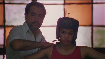 Movie still from “Girlfight” (2000), directed by Karyn Kusama – A man and a woman wearing boxing helmets; Medium shot, Low angle