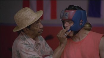 Movie still from “Girlfight” (2000), directed by Karyn Kusama – An older man and a young man wearing boxing helmets; Close Up shot, Over the shoulder angle