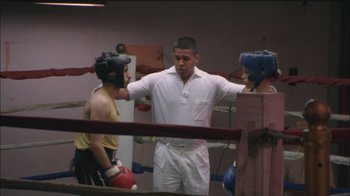 Movie still from “Girlfight” (2000), directed by Karyn Kusama – A man standing in the corner of a boxing ring; Medium shot, Over the shoulder angle