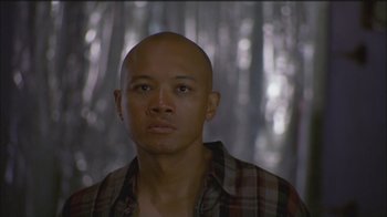 Movie still from “Girlfight” (2000), directed by Karyn Kusama – A bald man with a plaid shirt is staring straight ahead; Close Up shot, Low angle