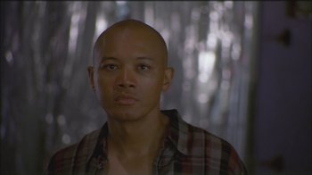 Movie still from “Girlfight” (2000), directed by Karyn Kusama – A bald man with a plaid shirt is looking straight ahead; Close Up shot, Low angle