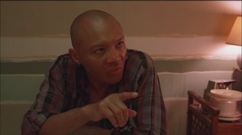 Movie still from “Girlfight” (2000), directed by Karyn Kusama – A bald man is pointing to his head; Close Up shot, Low angle