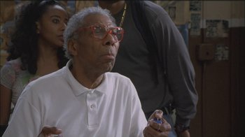 Movie still from “Girlfight” (2000), directed by Karyn Kusama – An older man with glasses is holding a cell phone; Close Up shot, Low angle