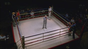 Movie still from “Girlfight” (2000), directed by Karyn Kusama – An old man standing in the middle of a boxing ring; Extreme Wide shot, High angle