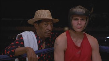 Movie still from “Girlfight” (2000), directed by Karyn Kusama – A man and a boy in a boxing ring; Medium shot, Low angle