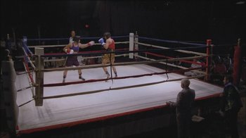 Movie still from “Girlfight” (2000), directed by Karyn Kusama – Two people in a boxing ring with a referee watching; Wide shot, High angle