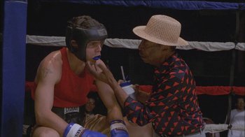 Movie still from “Girlfight” (2000), directed by Karyn Kusama – A man in a boxing ring getting his teeth brushed by another man; Close Up shot, Over the shoulder angle