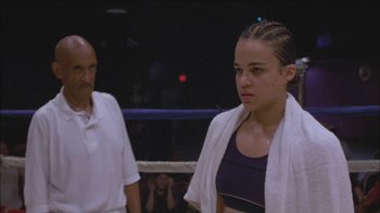 Movie still from “Girlfight” (2000), directed by Karyn Kusama – A young woman standing in a boxing ring with an older man watching; Close Up shot, Low angle