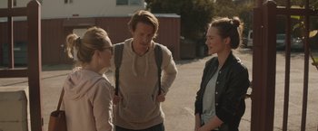 Movie still from “Gloria Bell” (2018), directed by Sebastián Lelio – A group of people standing next to each other on a street; Medium shot, Over the shoulder angle