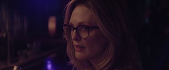 Movie still from “Gloria Bell” (2018), directed by Sebastián Lelio – A person wearing glasses and looking to the side; Close Up shot, Over the shoulder angle