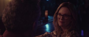 Movie still from “Gloria Bell” (2018), directed by Sebastián Lelio – A person sitting in a room at night; Close Up shot, Over the shoulder angle