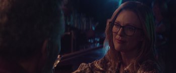 Movie still from “Gloria Bell” (2018), directed by Sebastián Lelio – A person sitting at a table in a room; Close Up shot, Over the shoulder angle