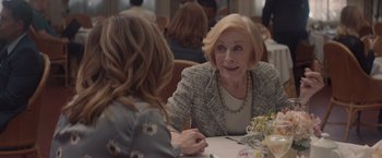 Movie still from “Gloria Bell” (2018), directed by Sebastián Lelio – A woman sitting at a table talking to another woman; Close Up shot, Over the shoulder angle