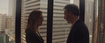 Movie still from “Gloria Bell” (2018), directed by Sebastián Lelio – A man and a woman standing next to each other in front of a window; Medium shot, Over the shoulder angle