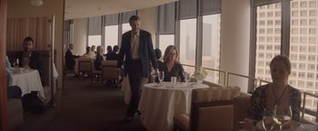 Movie still from “Gloria Bell” (2018), directed by Sebastián Lelio – A man and a woman at a table in a restaurant; Wide shot, High angle