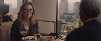 Movie still from “Gloria Bell” (2018), directed by Sebastián Lelio – A woman sitting at a table with a plate of food; Medium shot, Over the shoulder angle