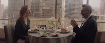 Movie still from “Gloria Bell” (2018), directed by Sebastián Lelio – A table set for a meal with a view of the city; Medium shot, Over the shoulder angle