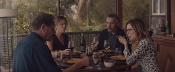 Movie still from “Gloria Bell” (2018), directed by Sebastián Lelio – A group of people sitting at a table with food; Medium shot, High angle