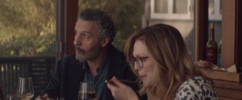 Movie still from “Gloria Bell” (2018), directed by Sebastián Lelio – A man and a woman sitting next to each other at a table; Medium shot, Over the shoulder angle