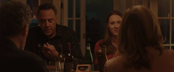 Movie still from “Gloria Bell” (2018), directed by Sebastián Lelio – A group of people sitting at a table with bottles of alcohol; Medium shot, Over the shoulder angle