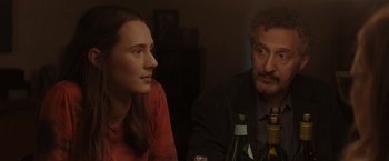 Movie still from “Gloria Bell” (2018), directed by Sebastián Lelio – A man and a woman sitting next to each other at a table; Close Up shot, Over the shoulder angle