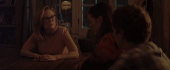 Movie still from “Gloria Bell” (2018), directed by Sebastián Lelio – Two women and a man are sitting at a table; Medium shot, Over the shoulder angle