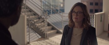 Movie still from “Gloria Bell” (2018), directed by Sebastián Lelio – A woman wearing glasses standing in front of stairs; Medium shot, Over the shoulder angle