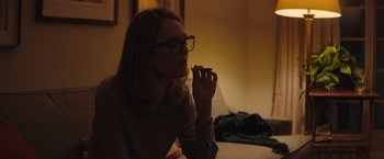 Movie still from “Gloria Bell” (2018), directed by Sebastián Lelio – A woman sitting on a bed with her hand in her mouth; Medium shot, Over the shoulder angle