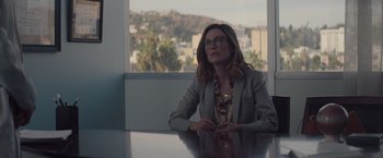 Movie still from “Gloria Bell” (2018), directed by Sebastián Lelio – A woman sitting at a table in front of a window; Medium shot, Over the shoulder angle