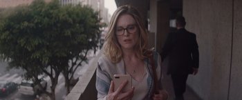 Movie still from “Gloria Bell” (2018), directed by Sebastián Lelio – A woman in glasses looking at her phone; Medium shot, Low angle