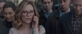 Movie still from “Gloria Bell” (2018), directed by Sebastián Lelio – A woman on a cell phone in front of a group of people; Close Up shot, Over the shoulder angle