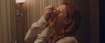 Movie still from “Gloria Bell” (2018), directed by Sebastián Lelio – A woman is putting something in her mouth; Extreme Close Up shot, High angle