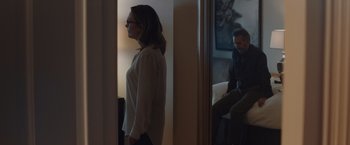 Movie still from “Gloria Bell” (2018), directed by Sebastián Lelio – A woman standing in front of a mirror looking in the mirror; Medium shot, Over the shoulder angle