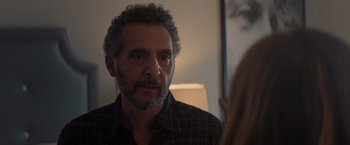 Movie still from “Gloria Bell” (2018), directed by Sebastián Lelio – A man looking at a woman in a mirror; Close Up shot, Over the shoulder angle