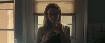 Movie still from “Gloria Bell” (2018), directed by Sebastián Lelio – A woman eating a bowl of cereal in front of a window; Close Up shot, Low angle