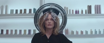 Movie still from “Gloria Bell” (2018), directed by Sebastián Lelio – A woman in a black shirt is in front of a mirror; Medium shot, Over the shoulder angle