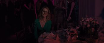 Movie still from “Gloria Bell” (2018), directed by Sebastián Lelio – A woman sitting at a table with a glass of red wine; Medium shot, Over the shoulder angle