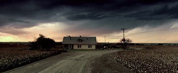 Movie still from “Glory Road” (2006), directed by James Gartner – A white house sitting on top of a dirt road; Extreme Wide shot, Low angle
