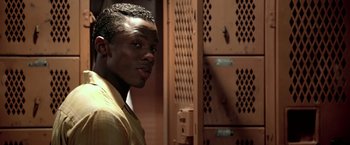 Movie still from “Glory Road” (2006), directed by James Gartner – A man standing in front of a metal locker; Close Up shot, Over the shoulder angle