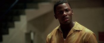 Movie still from “Glory Road” (2006), directed by James Gartner – A man in a yellow shirt is looking at the camera; Close Up shot, Low angle